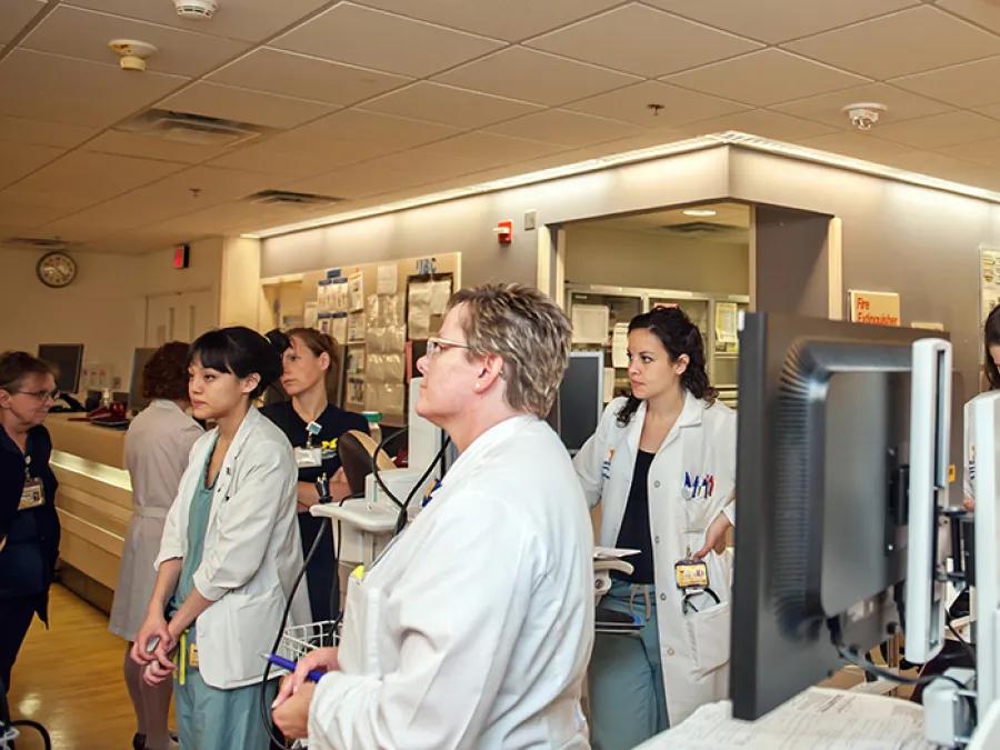residents making their rounds in the Neuro ICU