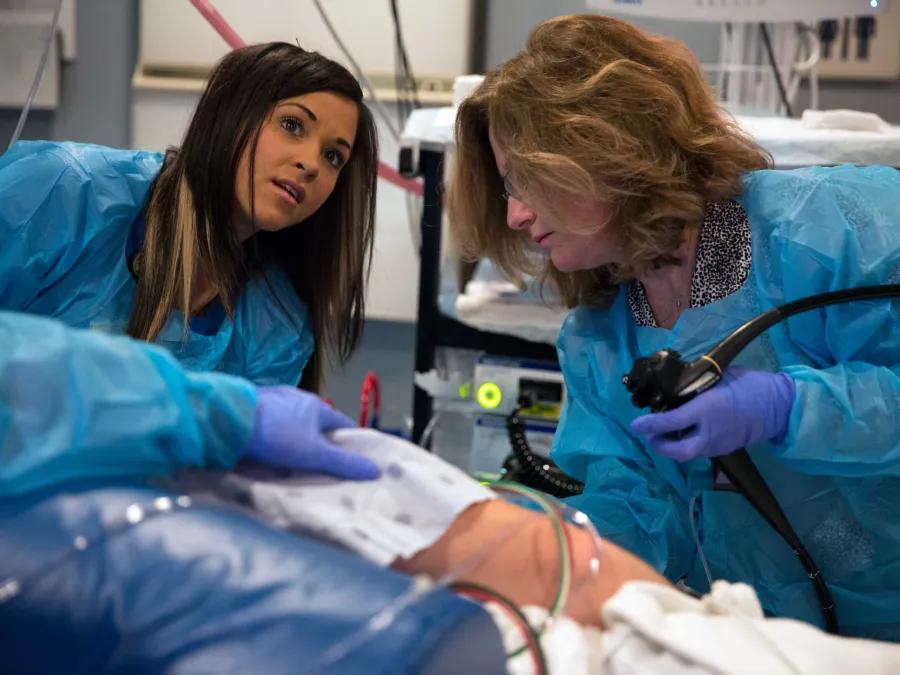 GI providers work on a patient during an exam