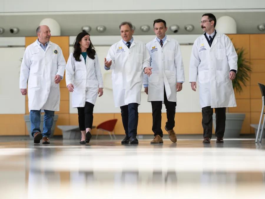 Allergy & Immunology doctors walk down the hallway while talking