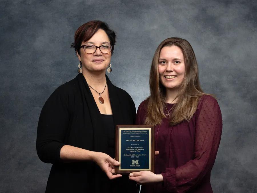 Anna Lisa Lawrence (right) and Mary O'Riordan (left) hold the MacNeal Award