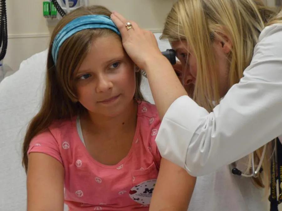 Doctor examines inside patient ear