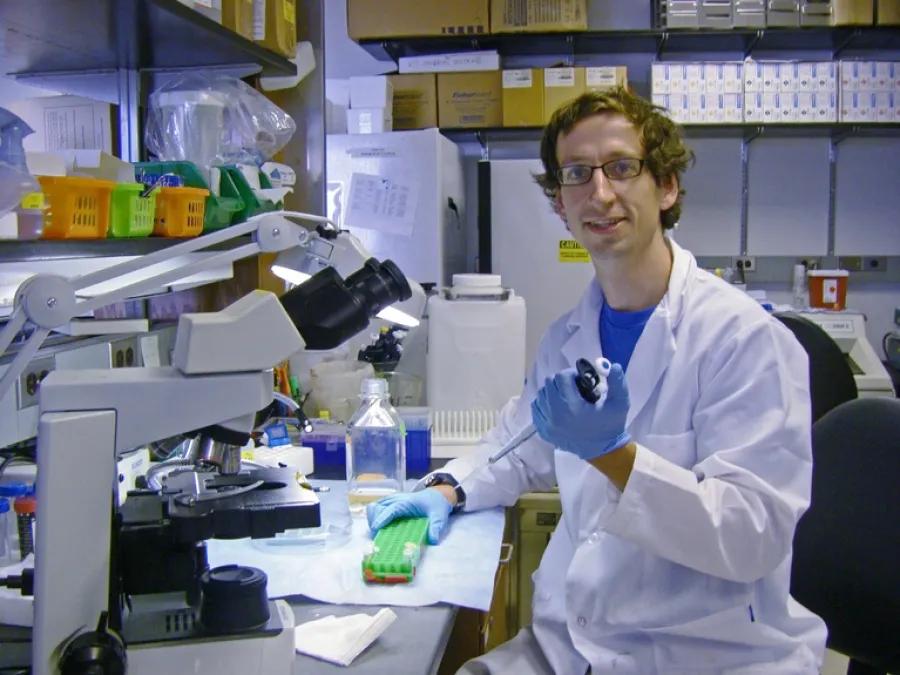 Carl Koschmann, M.D., working in his lab.