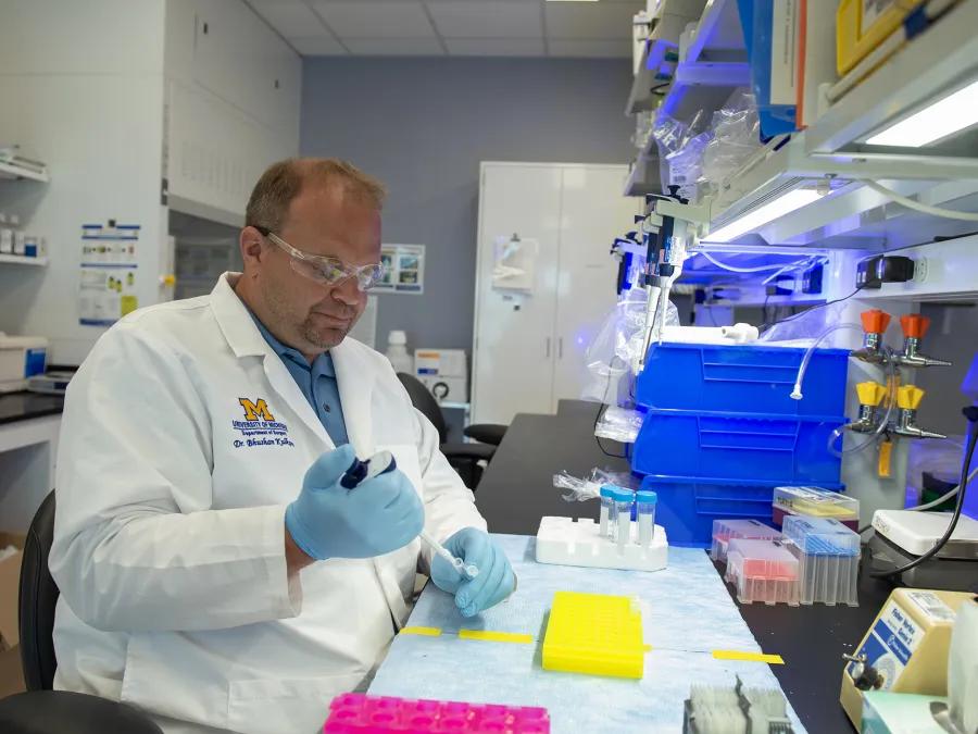 Lab member working with equipment in the lab