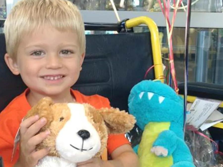 Child hugging a plush