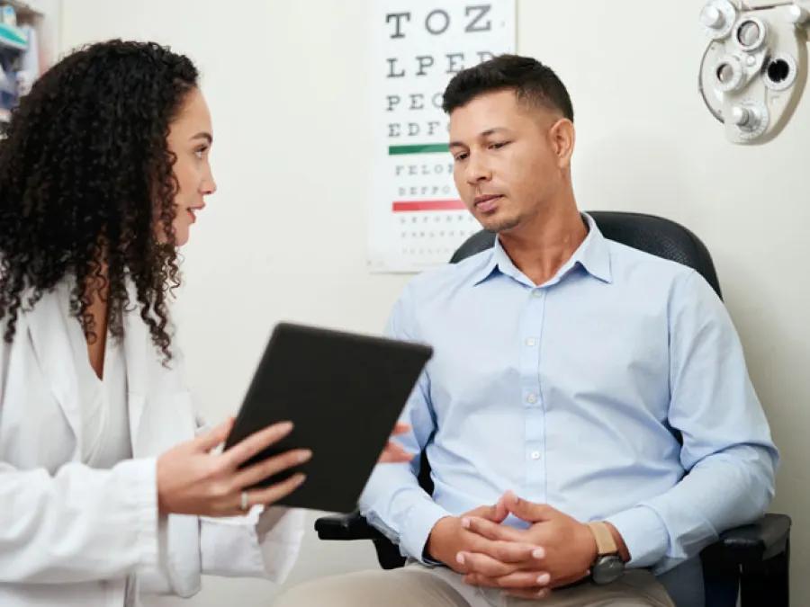 Man at Optometry Exam reviewing results with Optometrist