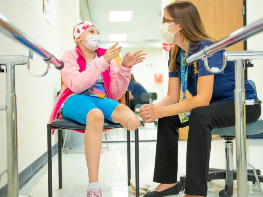 Rehab specialist sitting with patient 