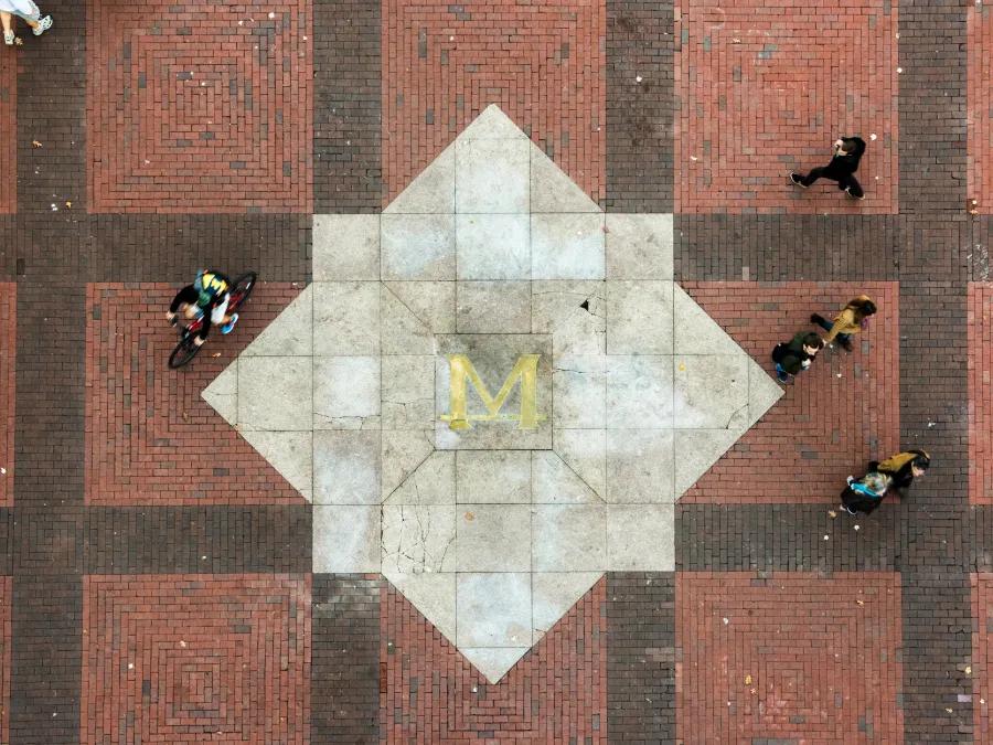 People walking and biking across the U-M diag