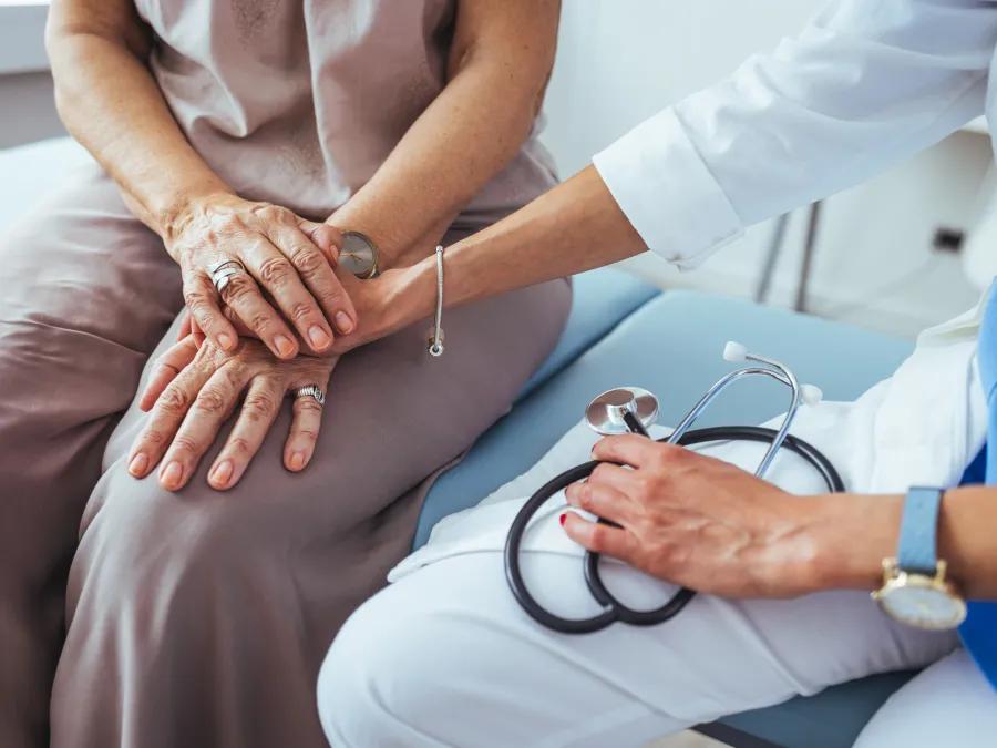 Doctor holding hand of a patient.