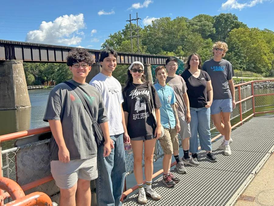 students by a river