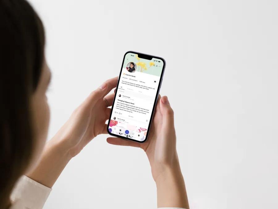 close-up of woman using CareCircle app on her phone
