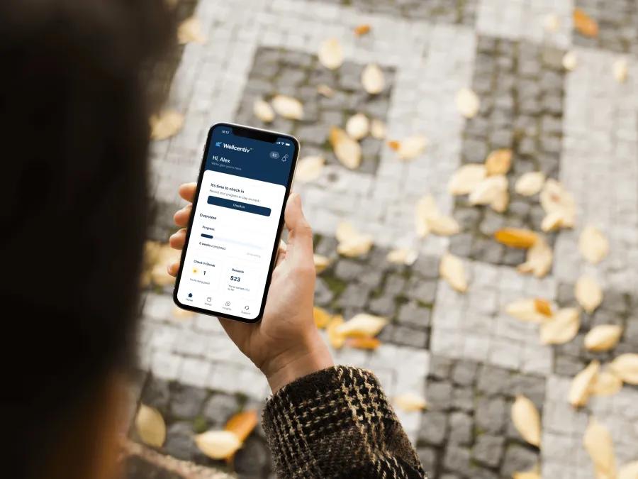 close-up of the WELLCENTIV app on a phone