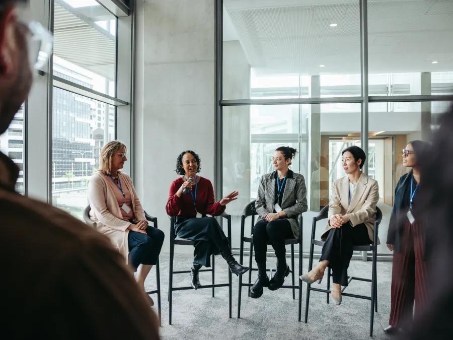 group of people sitting in a circle and talking