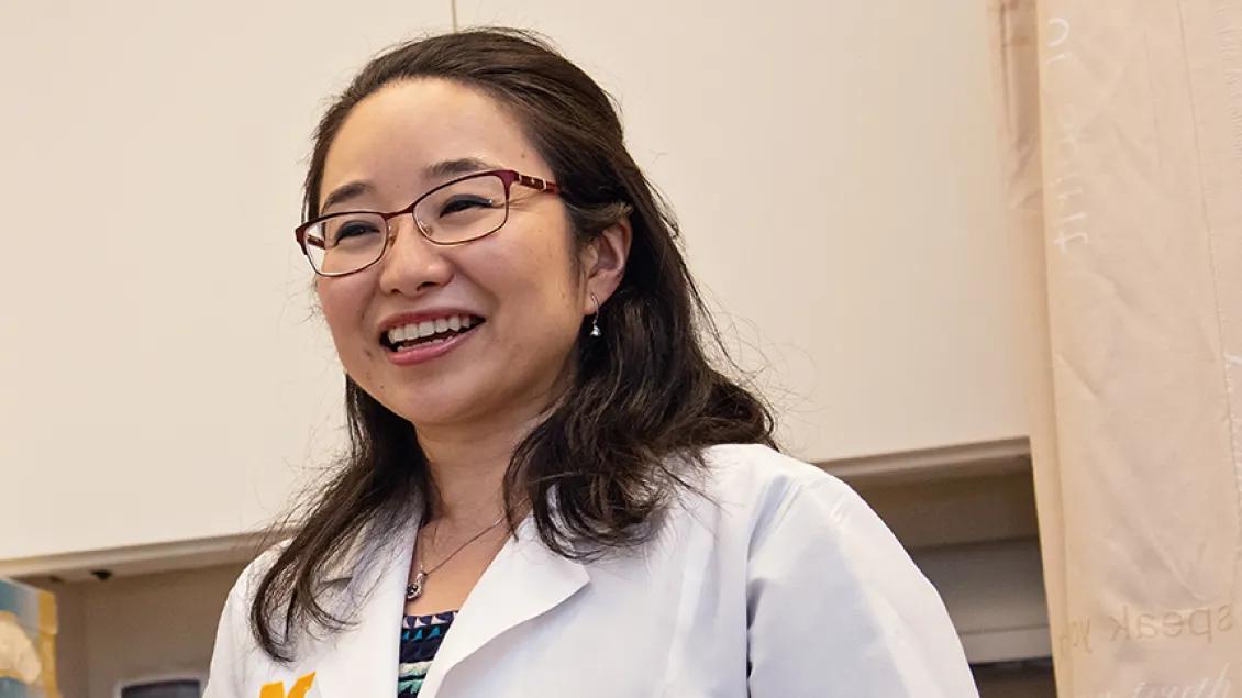 Dr. Aki Morikawa in the clinic talking to a patient