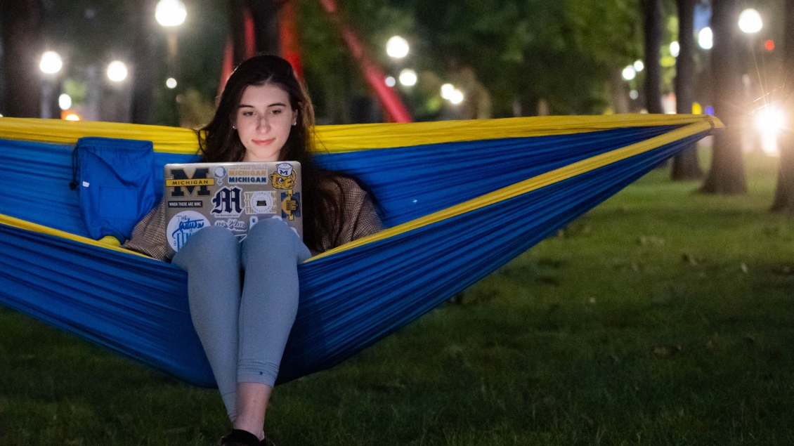 Student in a hammock with a laptop