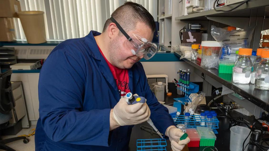 man using pipette in laboratory 