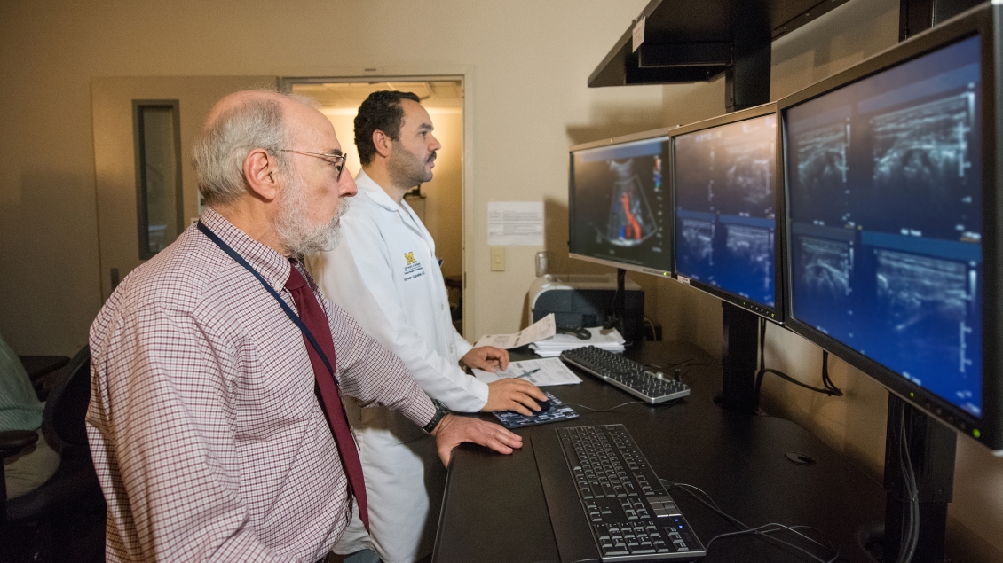 doctors looking at radiology scans 