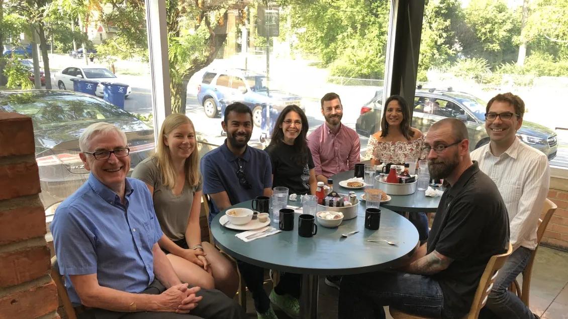 Pharmacology peers sitting at a restaurant table 