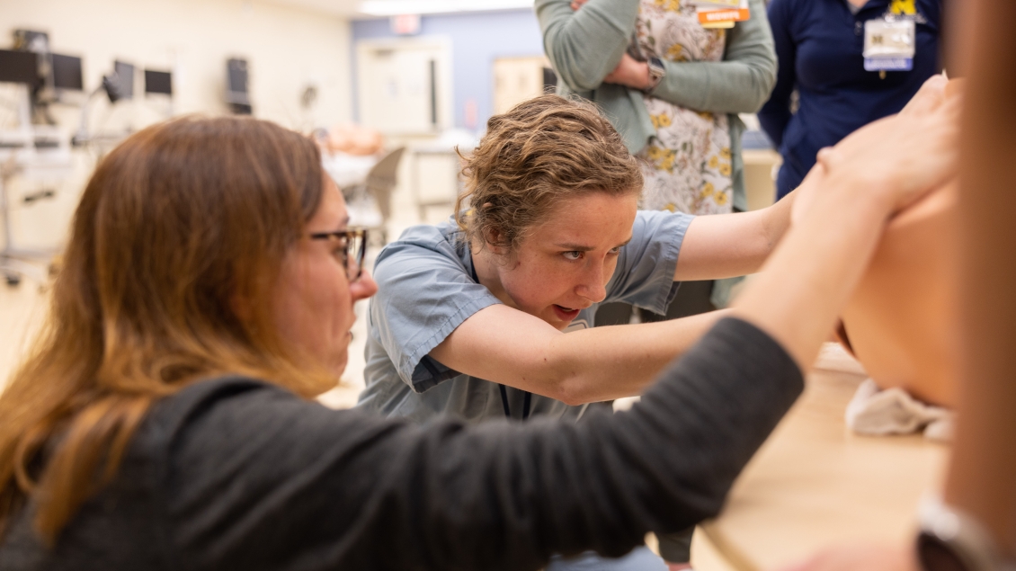 Teacher assisting student during simulation delivery