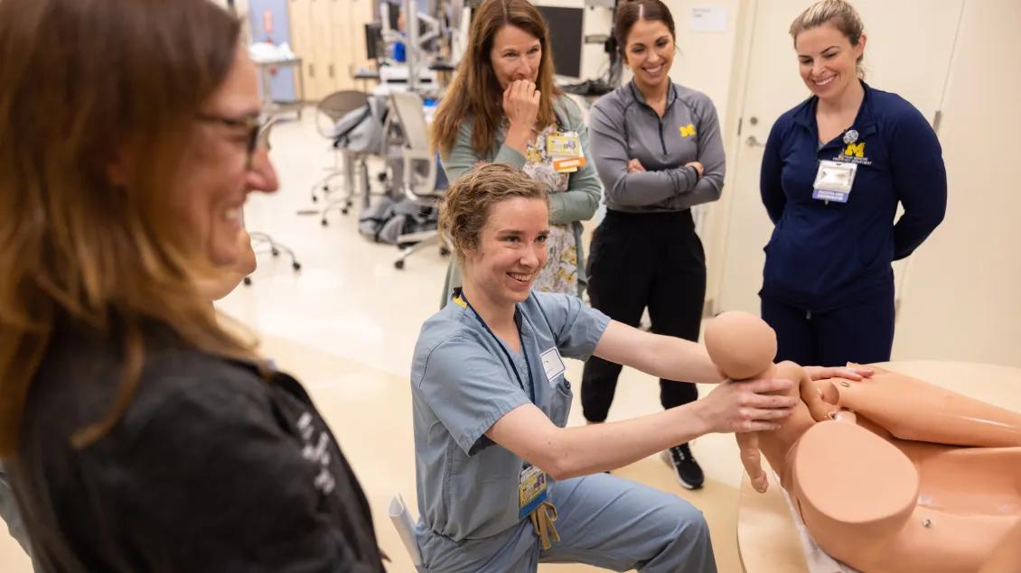 Student smiles after completing simulation delivery 