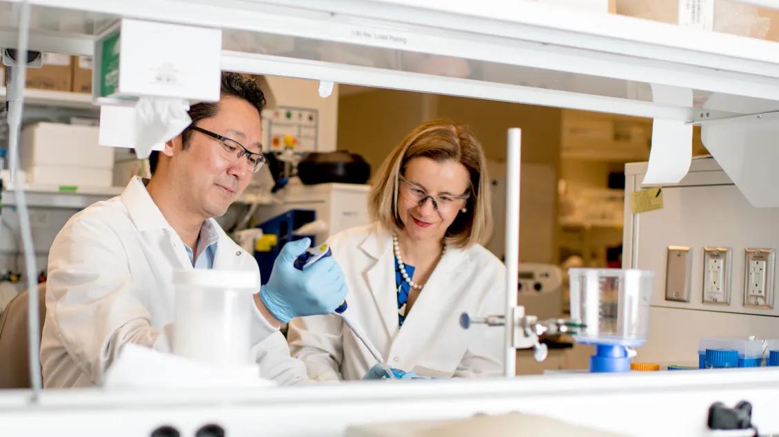 James Moon and Anna Schwendeman in a lab