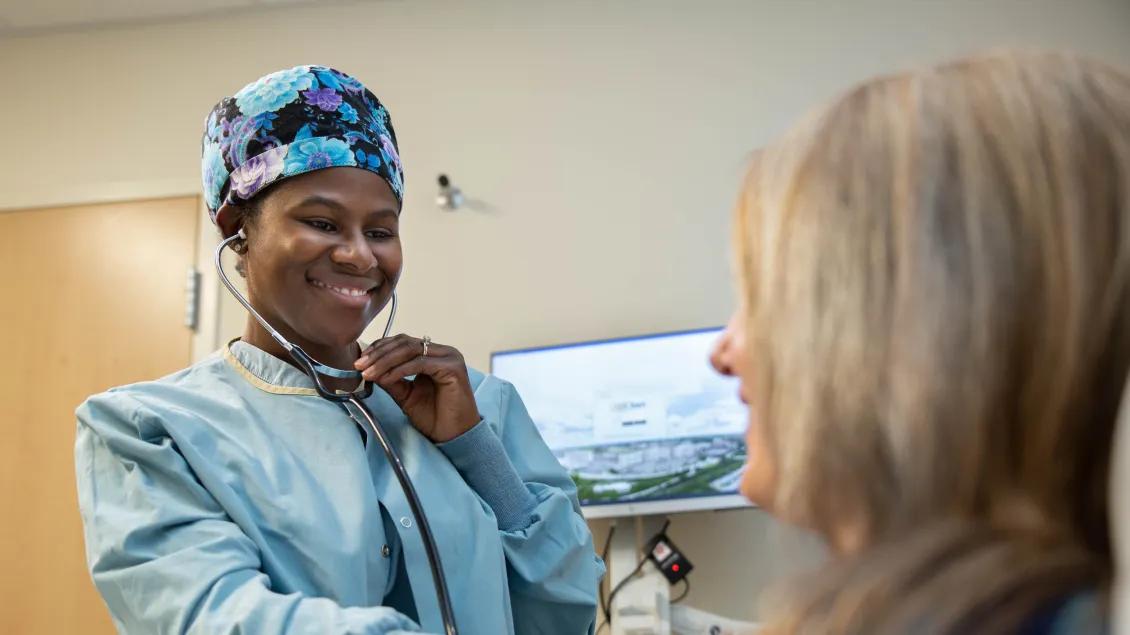doctor smiles at patient in bed