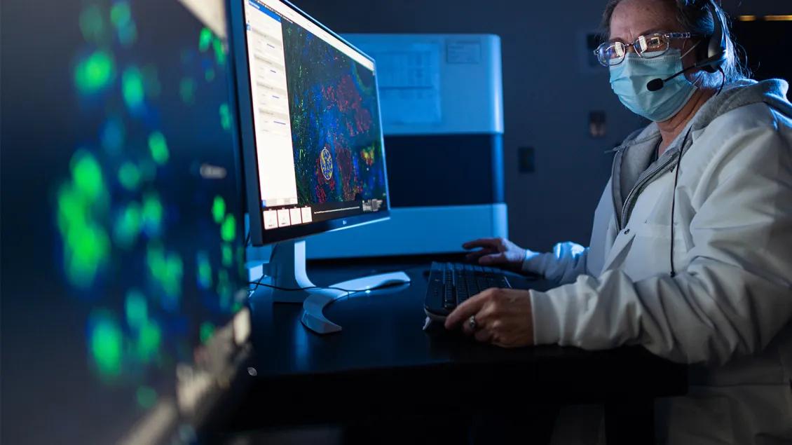 woman working in lab at computer screens