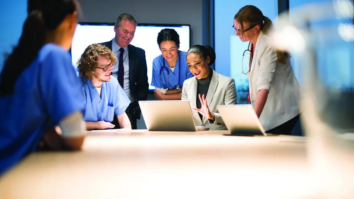 Photo of a group of medical staff around a computer