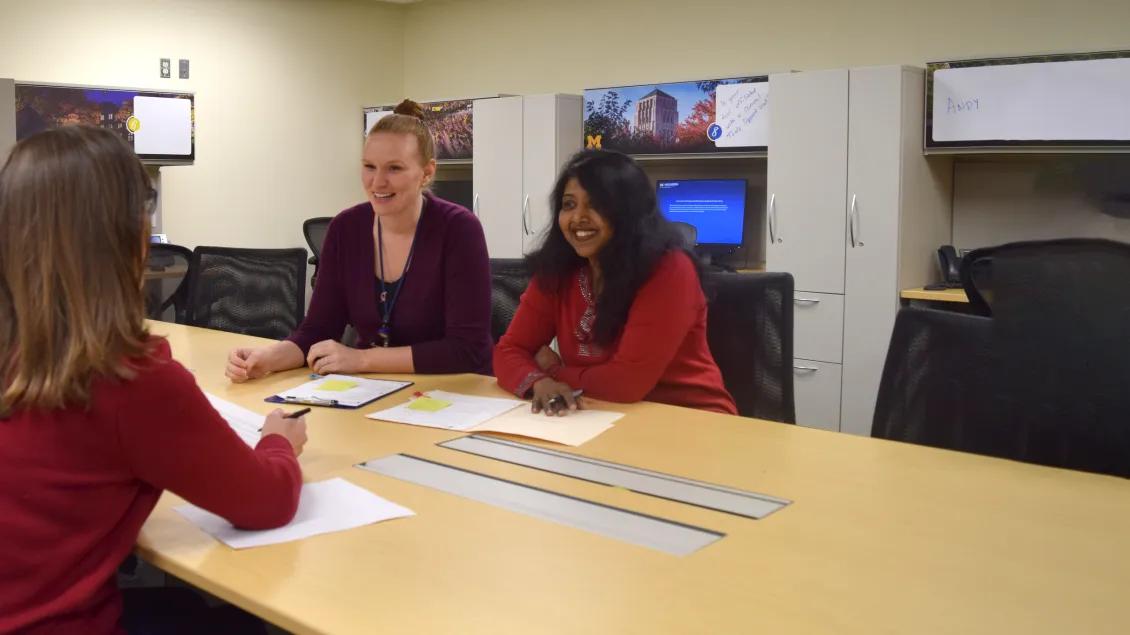Photo of four female study coordinators sitting at a table at UH South