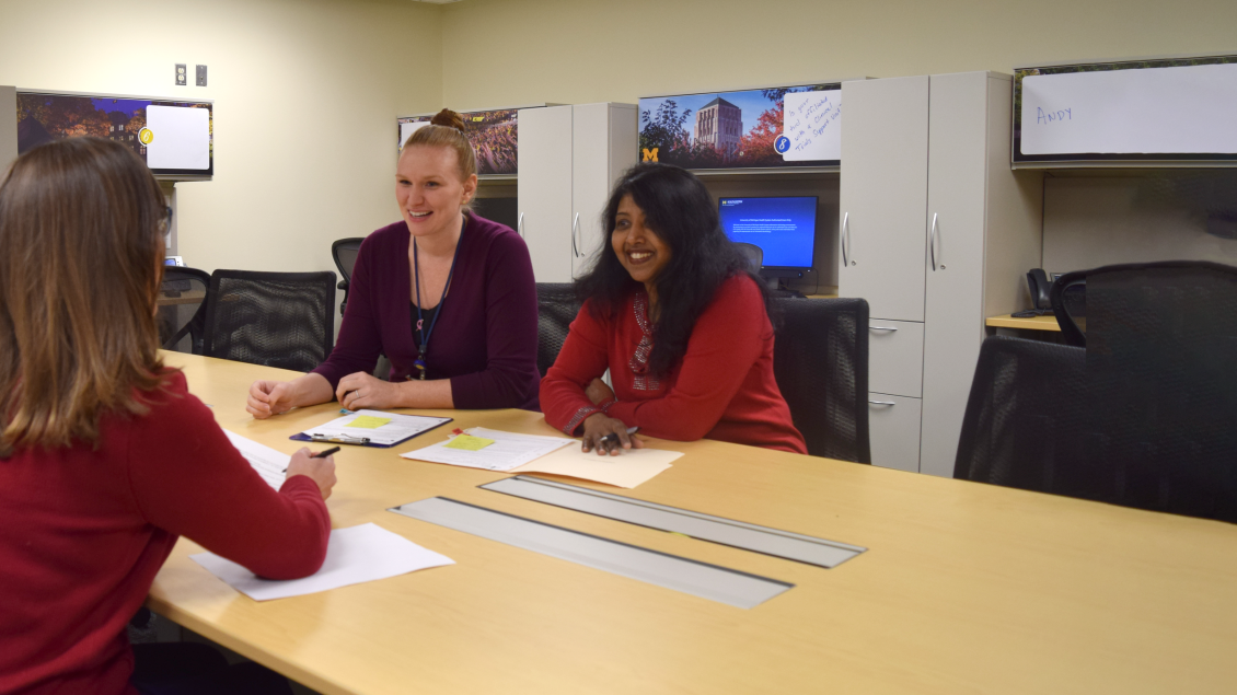 Photo of four female study coordinators sitting at a table at UH South