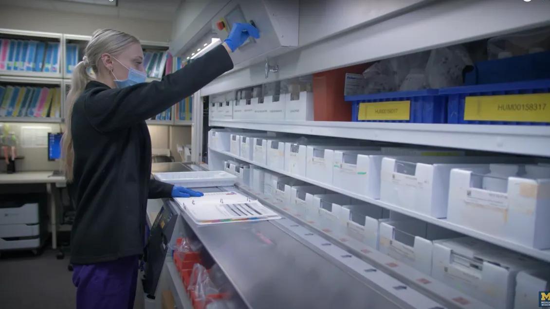 Photo of research pharmacy staff working in front of large ID storage
