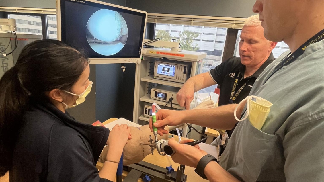 Student and professor learn how to use scope on patient during simulation 