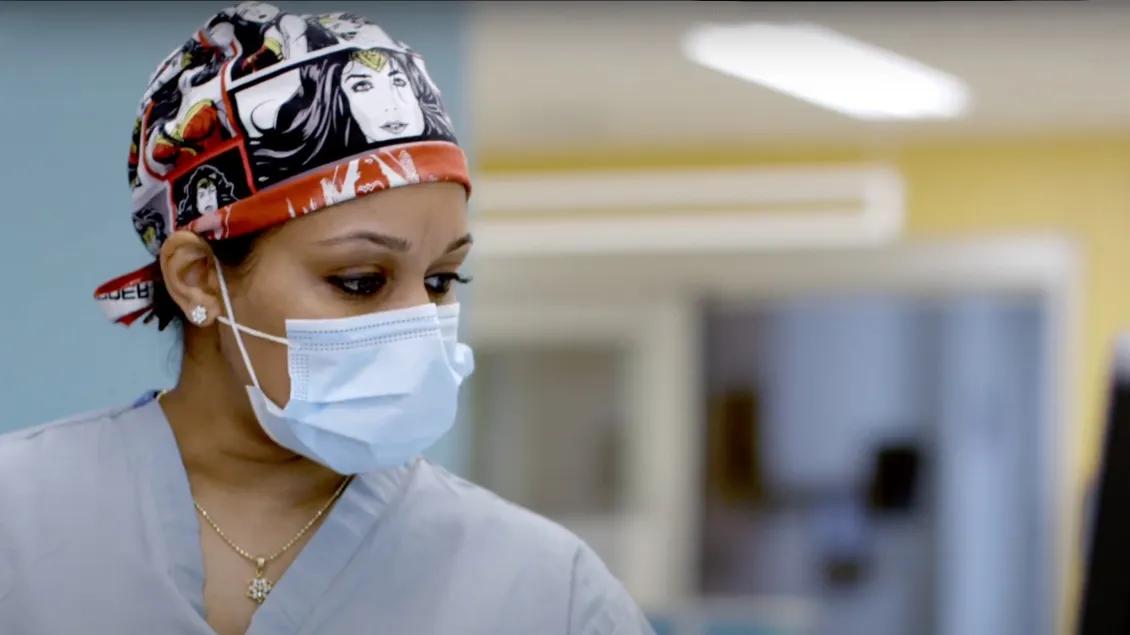 a person wearing a mask and scrub hat