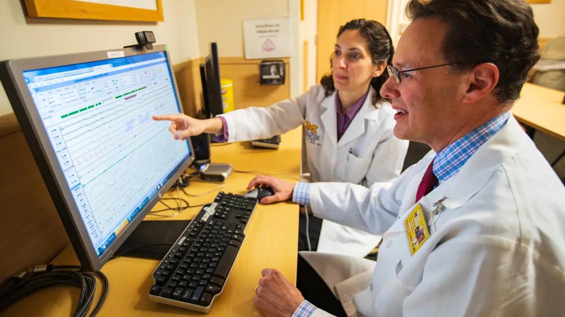 Neurology providers point to a computer screen