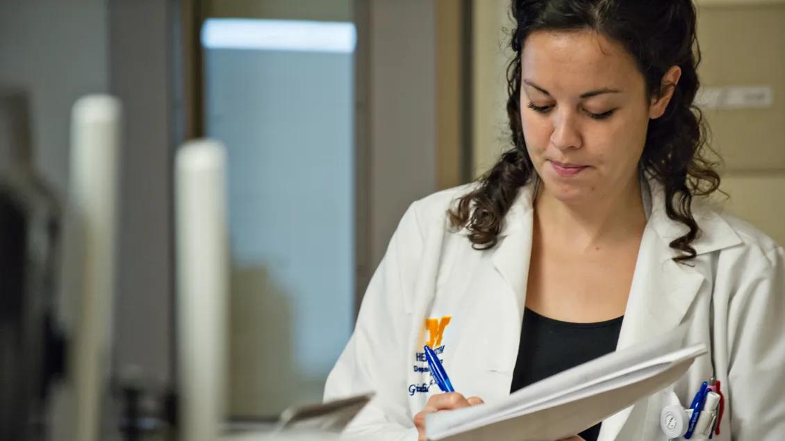 doctor taking notes in the neurology unit