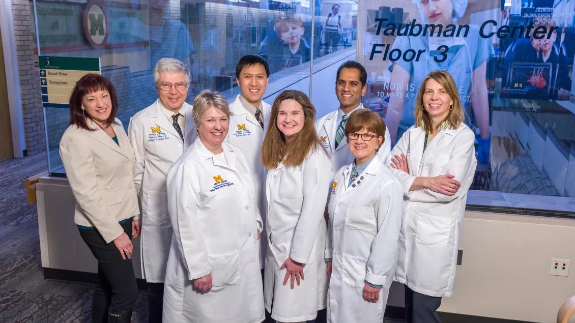 a group of people in white coats