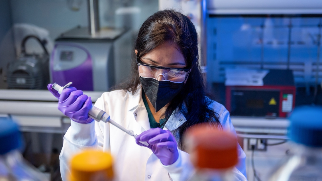 A dermatology researcher works in the lab