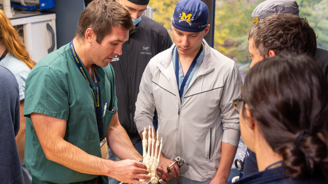A group of people standing around a skeleton