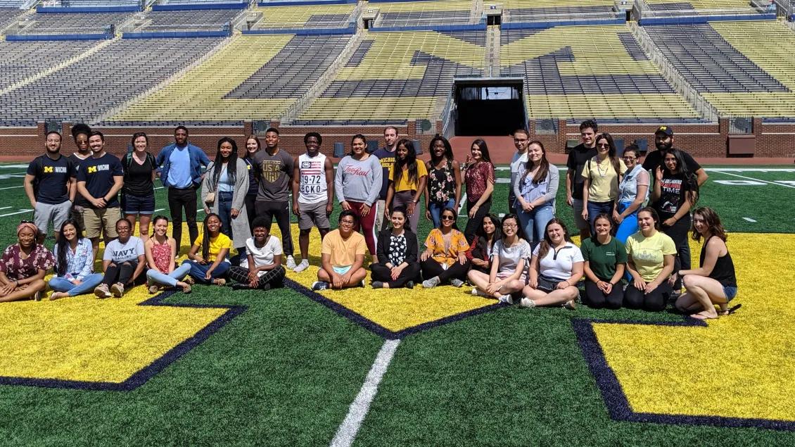 a group of people posing for a photo on a football field