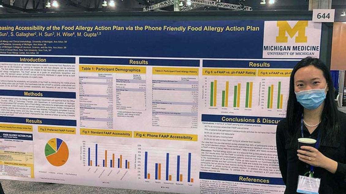 Fellow standing next to poster on food allergy data