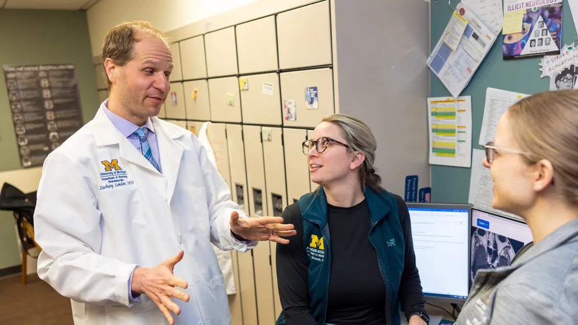 Photo of faculty talking to study team