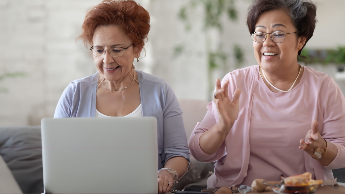 Two women watch an online video