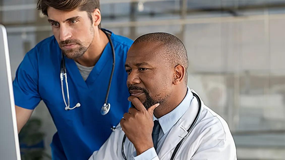 Doctors looking at the computer screen.