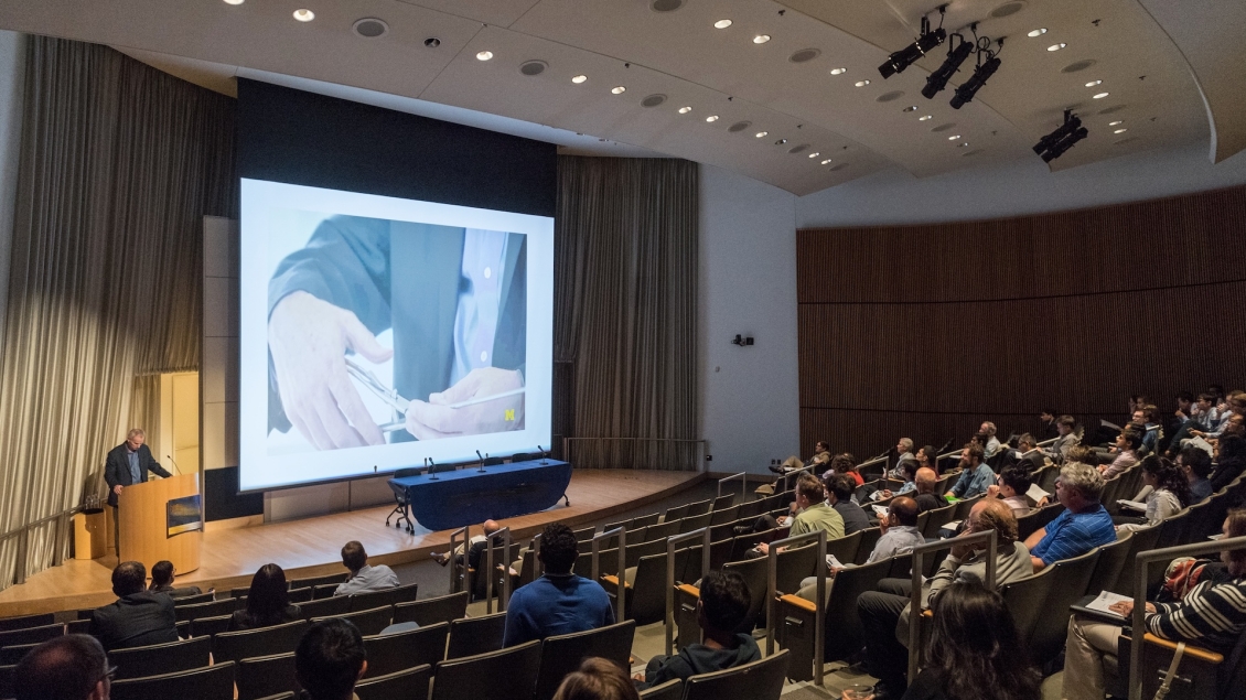 A speaker and attendees at an event in Kahn Auditorium at BSRB