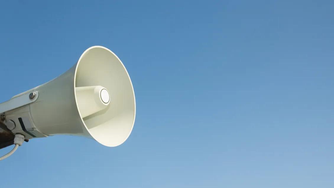 Megaphone against blue sky background