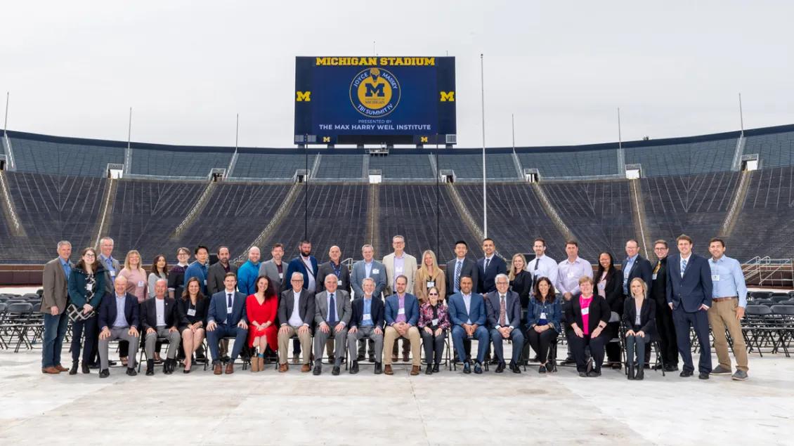 A group photo taken in Michigan Stadium of the Weil Institute team and attendees of the Joyce Massey TBI Summit.