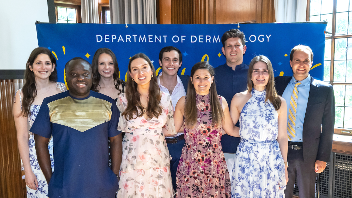 Dermatology Residency Class of 2024 stands in front of "Congratulations" banner