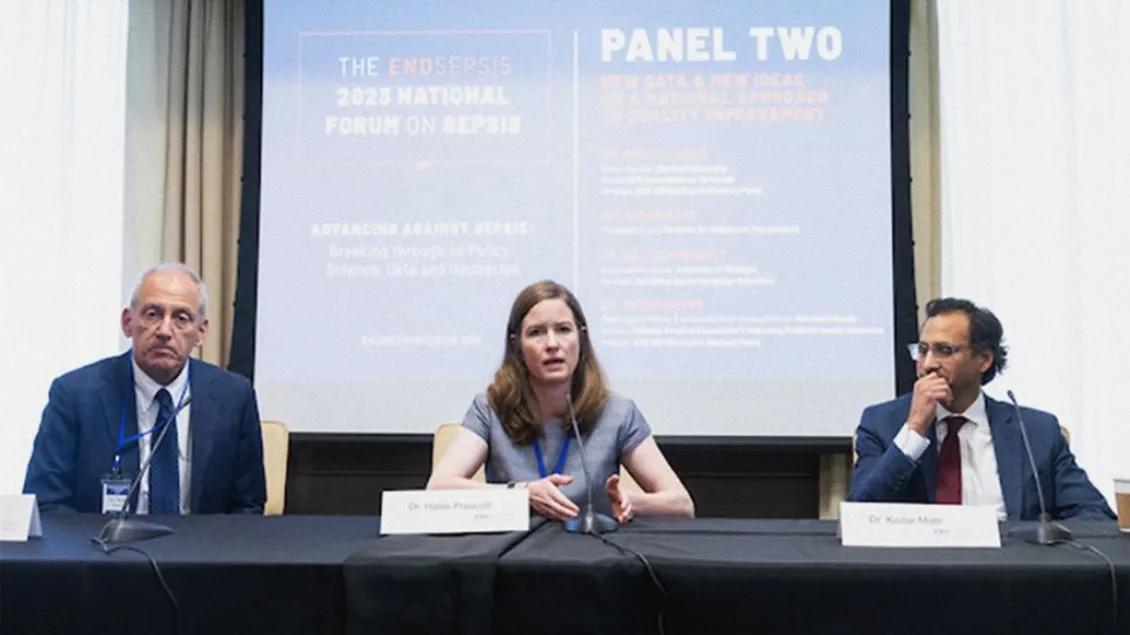 Three people speaking at a panel