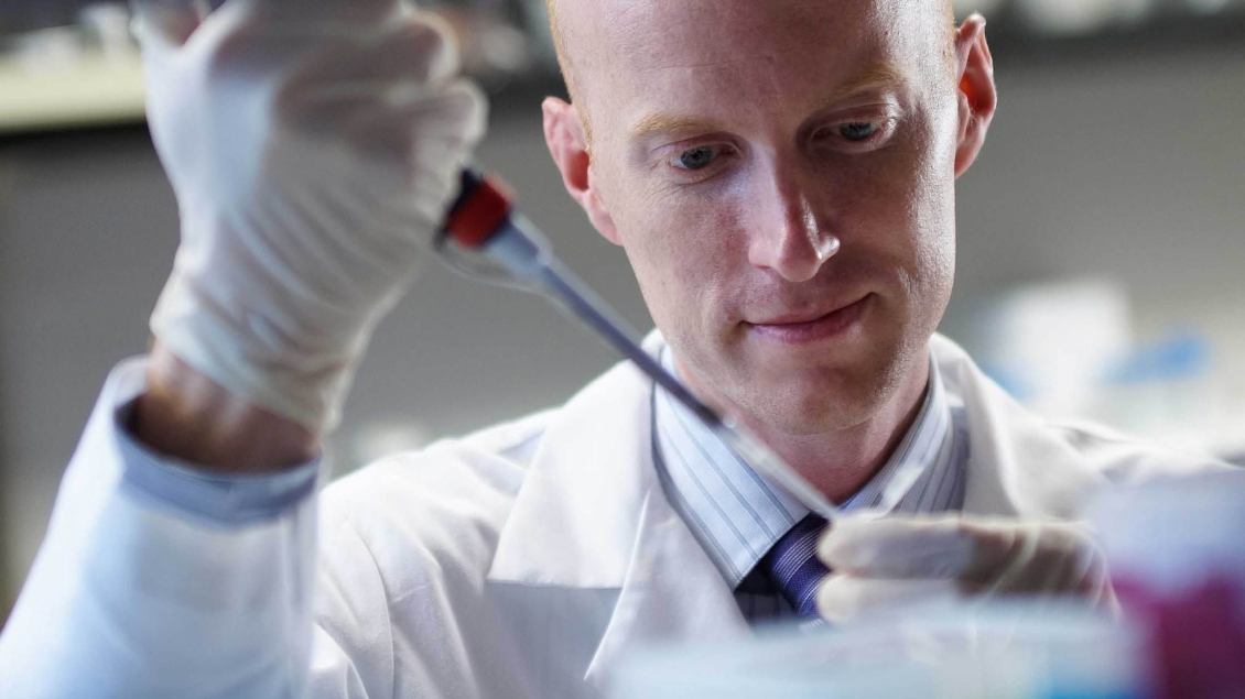 A researcher working with lab equipment