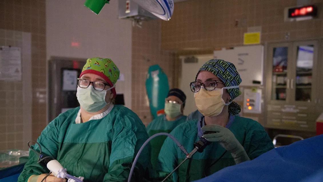 two female doctors operant on an active surgery 