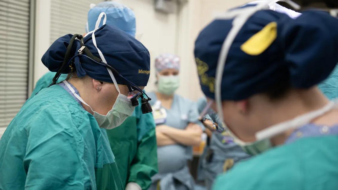 surgeon actively operates on patient 